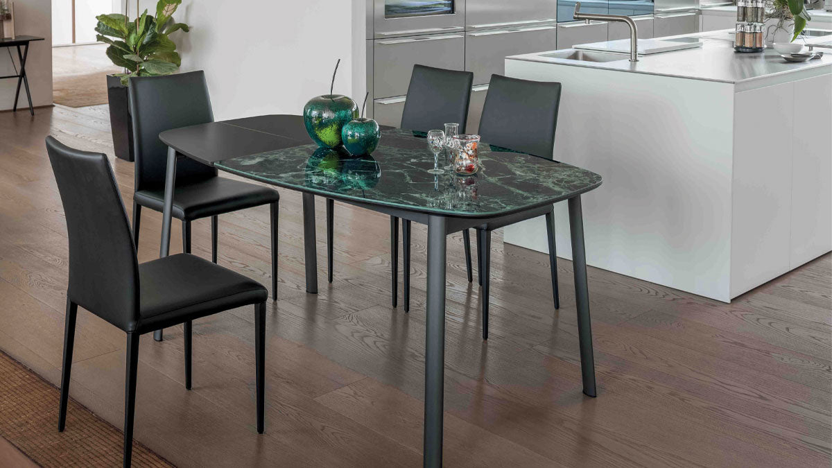 Paddington dining table with green marble top and black chairs in a kitchen setting