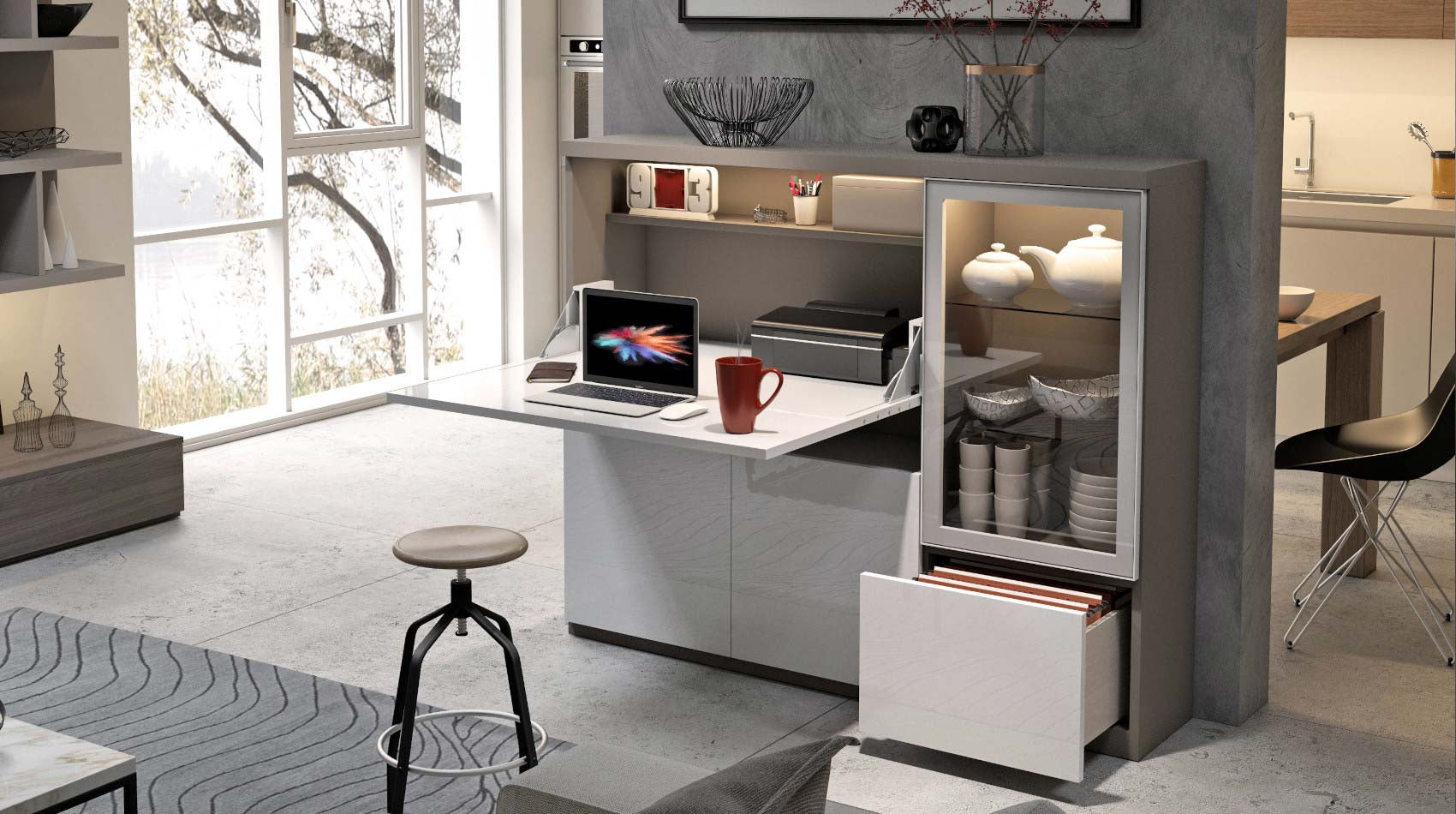 Modern kitchen with a home office in grey and white, laptop, mug, and decorative items.