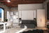Modern living room with our simplicity sofa wall bed, wardrobe, and kitchen area.