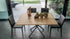 Dining table with chairs and decorative items in a modern indoor setting